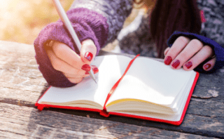 women writing in journal